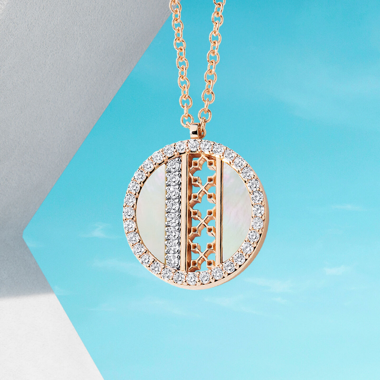 Birks Dare to Dream mother-of-pearl and diamond pendant on a blue background.